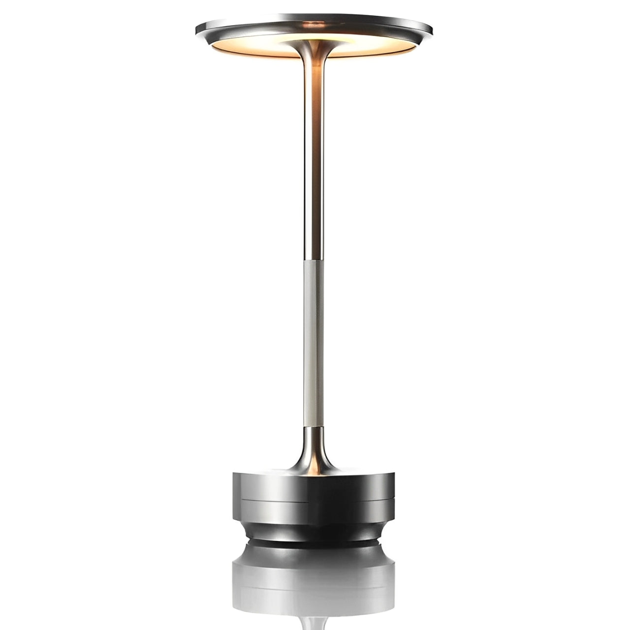 A sleek, modern silver table lamp with a circular top and slender pole, reflecting softly on a surface below.