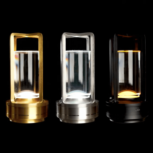 Three wireless table lanterns in gold, silver, and black, each with a transparent glass section, glowing in the dark.